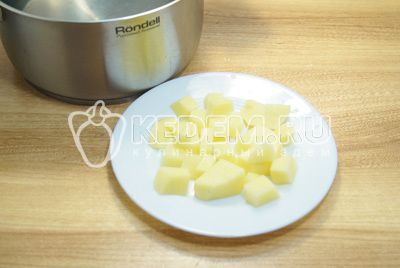 In der кастрюле вскипятить воду, картофель очистить и нарезать кубиками, варить 3-5 минут.